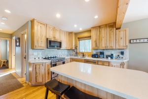 a kitchen with wooden cabinets and a white counter top at American Way Chalet in Breckenridge +29 photos