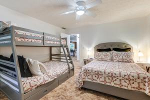 a bedroom with two bunk beds and a ceiling fan at Hiwassee River Gem with Huge Decks Great for Groups in Mountain Scene