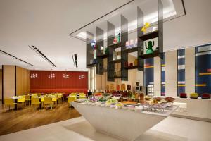 a restaurant with a table with food on it at Aloft Seoul Myeongdong in Seoul