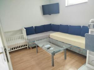 a living room with a couch and a table at Apartman Ivana in Slavonski Brod