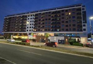 a large building with cars parked in front of it at Park Vila apartment in Belgrade