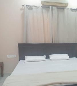 a bed with two white pillows in a bedroom at 13 BHK AC Villa Hyd,15 mins from Airport in Hyderabad