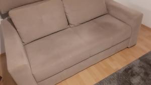 a white leather couch in a living room at CenterZeroZoneOne in Banja Luka