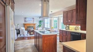 a kitchen with wooden cabinets and a dining room at Diana House in Charlottetown