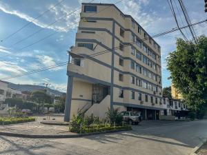 a tall building on the side of a street at Apartaestudio Moderno San Fernando Sector Estadio in Cali