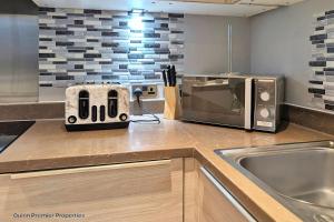 La cocina está equipada con tostadora y microondas. en Deluxe Croydon Apartment - NHS & Professionals, en Londres 14 fotos más