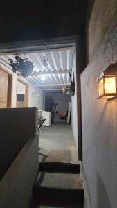 a hallway with stairs leading to a room at HOSTEL da FLORESTA - centro BH in Belo Horizonte