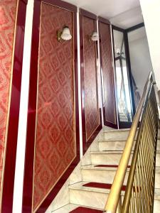 a staircase in a house with a red and white wall at Bulevar in Valjevo
