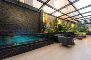 a lobby with a large aquarium in a building at Tuvana Hotel in Jeddah
