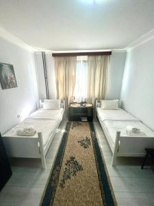 duas camas em um quarto com janela em Bulevar em Valjevo