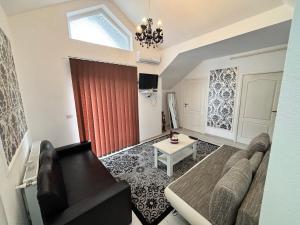 a living room with a couch and a red curtain at Sara Apartament in Lugoj