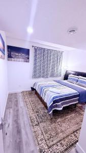a bedroom with a bed and a rug at Modern Comfort Stay Near Airport in Edmonton