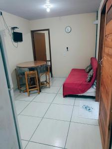 a small room with a bed and a table at Le case Rosse in Itapoa