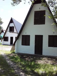 een wit gebouw met zwarte deuren en ramen bij Alpinas El Chusmo 2 in Villa Ciudad Parque