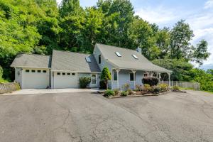 a house with a garage and a driveway at Ski, Hike and Fish Mtn-View Maggie Valley Retreat in Maggie Valley