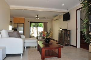 a living room with a white couch and a table at Double Island Dream - Rainbow Beach in Rainbow Beach