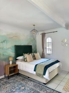 a bedroom with a large bed and a chandelier at Little Studio in Tokai in Tokai