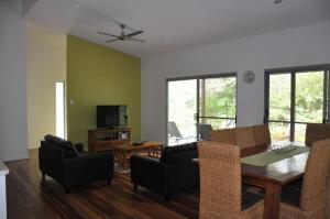 a living room with a dining room table and chairs at Csalt - Rainbow Shores in Rainbow Beach