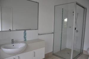 a bathroom with a sink and a glass shower at Csalt - Rainbow Shores in Rainbow Beach +7 photos
