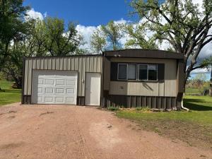 a house with a garage and a driveway at Dorothy's Hideaway in Hulett