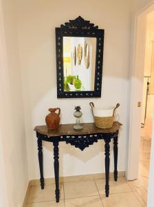 a mirror on top of a table in a room at Quinta das palmeiras - Aldeia do Pico in Grândola
