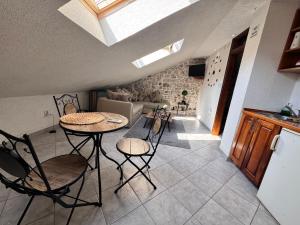 a kitchen with a table and chairs in a room at Last Summer hotel Kotor in Kotor +30 photos