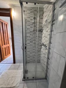 a shower with a glass door in a bathroom at Last Summer hotel Kotor in Kotor +32 photos