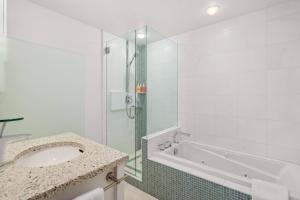 a bathroom with a tub and a sink and a shower at Aspen Villas/Bleeker Street Townhome 2 plus Den in Aspen +33 photos