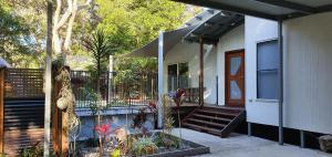 a front porch of a house with a staircase at Shelleys - Rainbow Shores in Rainbow Beach