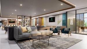 a living room with a couch and chairs at Holiday Inn Nashville Airport by IHG in Nashville
