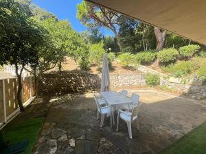 a patio with a table and chairs and an umbrella at Casa Smeraldo in Cavo