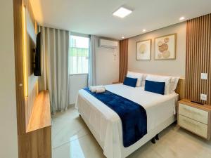a bedroom with a large bed and a television at Ap 2 quartos espaçoso in Natal
