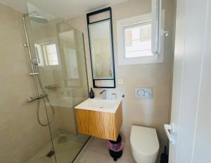 a bathroom with a sink and a shower and a toilet at Arnados Residence in Kékhros +21 photos