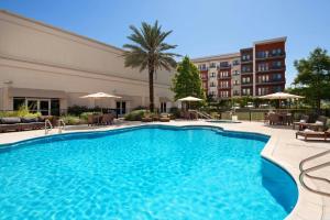 a pool in a hotel with chairs and a building at The Westin Austin at The Domain in Austin