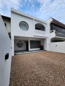 Casa blanca con entrada de grava en The Seven Room Near Tebrau and Mount Austin, en Johor Bahru