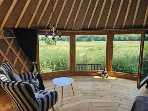 a living room with two chairs and a table at Glamour-Camping in Hanshagen