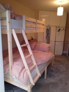 a bedroom with two bunk beds with pink sheets at Semi Rural 3 Bed, loads of space in Pontypridd