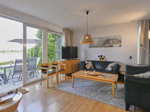 a living room with a couch and a table at Aan de oever in Stevensweert