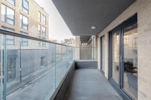 a balcony of a building with glass windows at Luxurious 2 Bedroom Apartment in Coulsdon