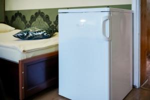 a refrigerator in a room with a bed at POKOJE GOŚCINNE IRGA in Starogard Gdański