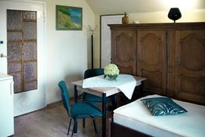 a room with a table and chairs and a bed at POKOJE GOŚCINNE IRGA in Starogard Gdański