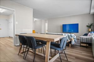a dining room with a wooden table and chairs at Stylish 2BR Arlington Near DC Free Parking & Gym in Arlington
