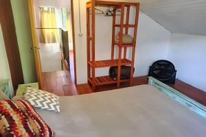 a room with a bed and a wooden shelf at Mi Casa Tu Casa D , apto mascotas in Lago Puelo