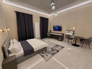 a bedroom with a bed and a desk and a table at Wot Luxury Silver Center in Arad