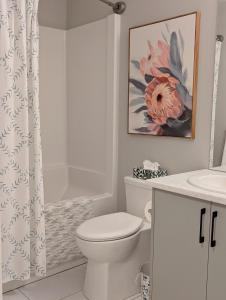a white bathroom with a toilet and a sink at Oakview Hideaway in Victoria +22 photos