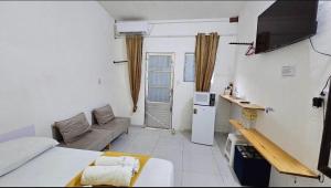 a small living room with a couch and a tv at Suite 1 - Centro de Convenções700m, AC, WIFI in Recife