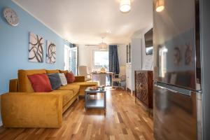 a living room with a couch and a table at KGV Stays - Ocean View City Center Apartment in Southampton