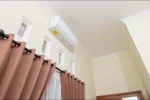 a room with curtains and a ceiling with a light at Kost Putri Exclusive Orchidee in Jatingaleh