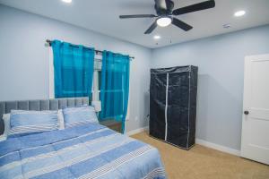 a bedroom with a bed and a ceiling fan at Cozy 2nd & 3rd Floor Retreat in Lewiston