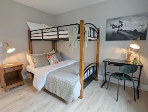 a bedroom with a bunk bed and a desk at Oakview Hideaway in Victoria